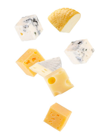 Pieces of various types of cheese. Maasdam, Brie, smoked goat cheese, and regular cheese fall in space. Isolated on white.の写真素材