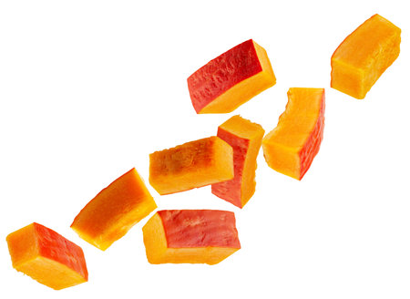 Rectangular slices of red pumpkin fly through space forming a chain. Isolated on white.の写真素材