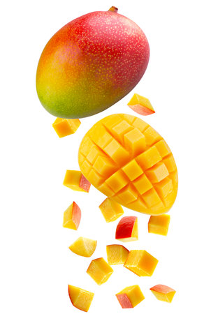 Whole mango, large slice of mango cut into square pieces and individual cubic and triangular pieces fall in space. Isolated on whiteの写真素材