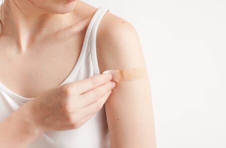 Protection of a sore spot with a plaster on the arm