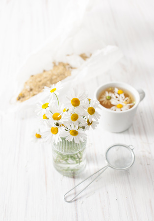 Recipes of traditional medicine with a decoction of chamomile at home. Immunity enhancement in alternative medicine. Recipes of the cosmetics with chamomile. An empty space to insert text.の写真素材