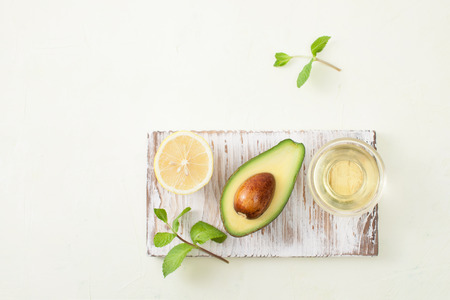 Avocado in cooking and preparing homemade cosmetics. Copy space text
