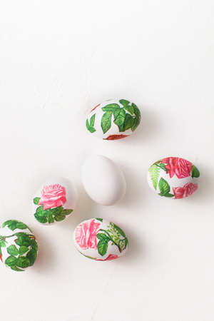 The process of creating decoupage on eggs in floral style. A delicate pink palette. Copy space text.の写真素材