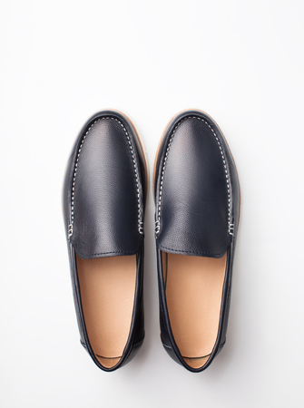 Dark men's fashion shoes on plain background. Top view. Copy space text.