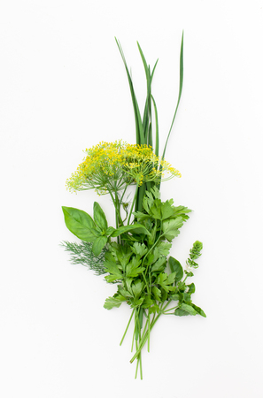 Spicy herbs on white for use in salads and marinades.の写真素材