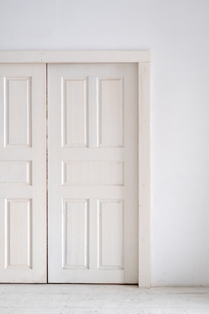 White double doors on a white wall.の写真素材