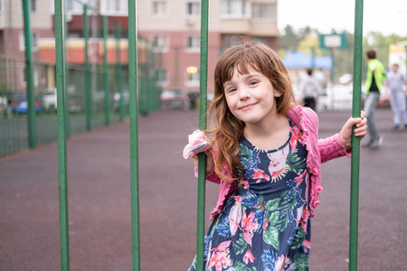 Girl five years old playing on the Playground in the city