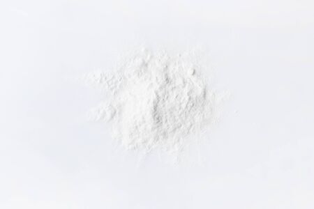 Baking soda on a white glossy background. The use of soda in cosmetics, everyday life and folk medicine. Copyspace textの写真素材