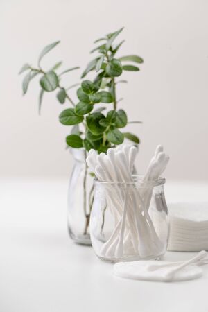 Cotton pads and sticks to remove makeup and cleanse the skin on grayの写真素材