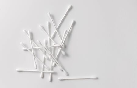 Cotton swabs to remove makeup and cleanse the skin on grey. Copy space text