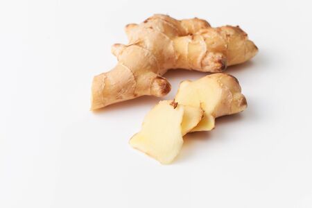 Young fresh cut ginger root on white background. Ginger root is used to increase immunity, to lose weight, whether it protects against colds and viruses. Space for textの写真素材