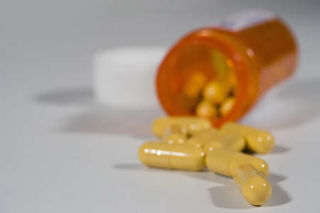 Pills spilling out of a prescription bottleの写真素材