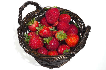 A basket of strawberries on a white backgroundの写真素材