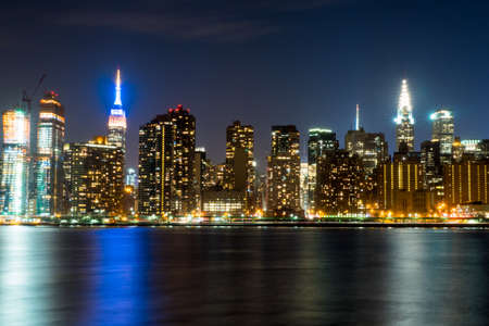 Manhattan skyline in New York City at night from across the East Riverの写真素材