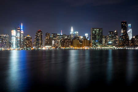 Manhattan skyline in New York City at night from across the East Riverの写真素材