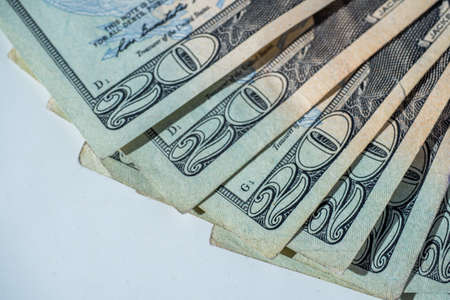 twenty dollar bills laying on a white backgroundの写真素材
