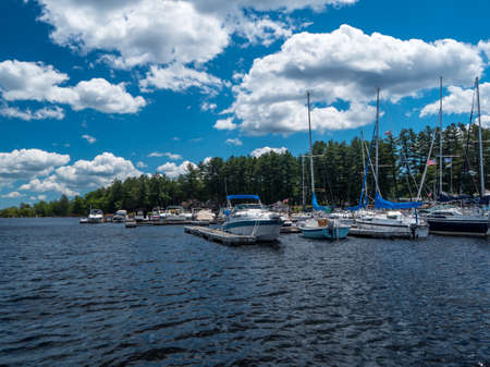 Boats docked at a marina on a lake - with a beautiful blue skyの写真素材