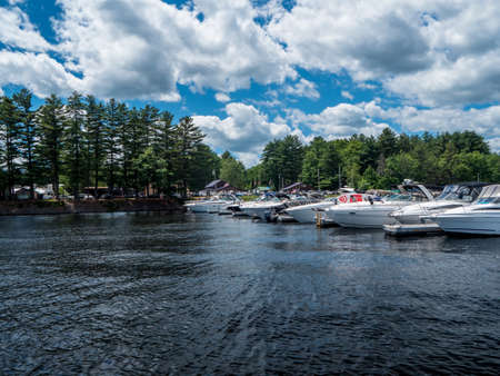 Boats docked at a marina on a lake - with a beautiful blue skyの写真素材