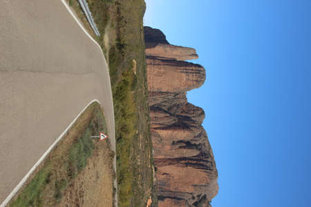 Panoramic view of the famous rock formations of Mallos de Riglos in Spain under a light blue backdropの写真素材