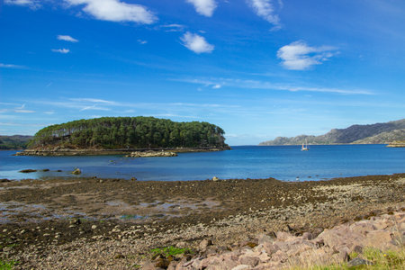 Scenic view of Shieldaig loch and island with blue sky and cloudscape background, Highlands, Scotland.の写真素材