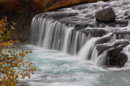 Hraunfossar (Borgarfjordur, western Iceland) is a series of waterfalls formed by rivulets streaming...