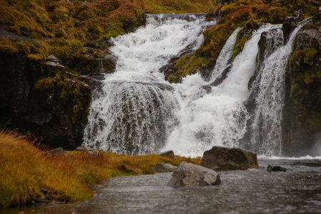 Fantastic ground level view of the Kirkjufellsfoss waterfall near the Kirkjufell mountainの写真素材