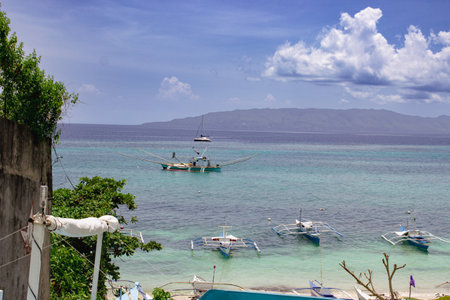 Tropical beach in the Philippines, with different typical boats.の写真素材