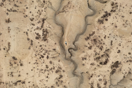 Aerial view of a man lying on the ground in the Abanilla desert or Mahoya desert in Murcia, Spain