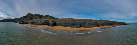 Panoramic aerial view of the rock-filled beaches of Calblanque and the Mediterranean Sea.