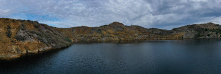 Panoramic aerial view of La Union Mining Park landscape and ocher-tinted water lake, called Red...