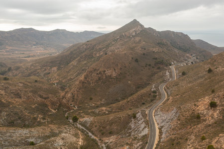 Aerial view of a beautiful S-shaped road in a desert area in La Union, Murcia.の写真素材