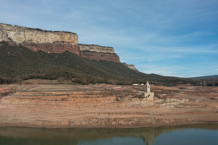 Aerial view of the Sau reservoir in drought, with the Romanesque tower of Sant Roma, Vilanova de Sau.の写真素材