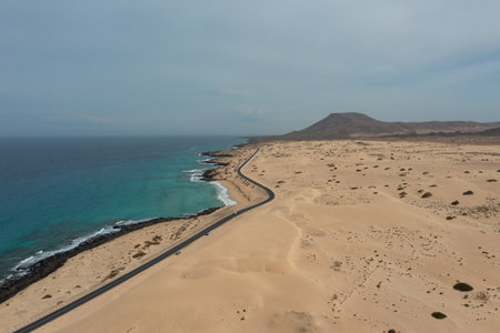 High-resolution aerial photograph of the road crossing the Corralejo Natural Park sand dunes in...