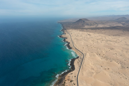 High-resolution aerial photograph of the road crossing the Corralejo Natural Park sand dunes in...