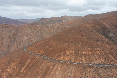 Scenic drone view of the desert mountains and curvy road near the famous viewpoint Risco de las PeÃ±itas.の写真素材