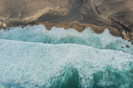 Aerial photograph of the wild and remote La Solapa Beach in Fuerteventura, a hidden gem of the Canary Islands.の写真素材