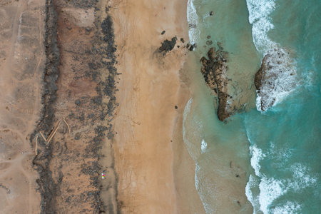 Scenic top-down view of Playa de las Escaleras, showcasing pristine shoreline, crystal-clear...