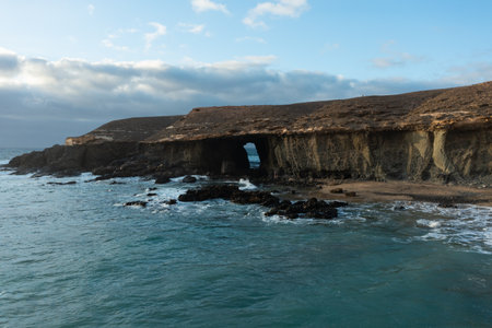 Breathtaking aerial landscape of Vigocho's sea cave and the volcanic coastline of Fuerteventura.の写真素材