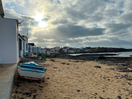 A small fishing boat stranded on the sandy beach of El Cotillo, Fuerteventura, Canary Islands. The...