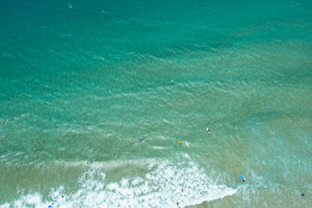 High-angle view of Playa del Castillo, Fuerteventura, featuring colorful kites in the sky and...