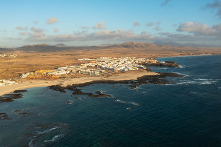 Scenic aerial panorama of El Cotillo coastal village and sandy beaches during sunset. Warm evening light over the Atlantic Ocean in Fuerteventura, Canary Islands, Spain.の写真素材