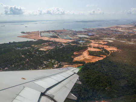 BATAM, INDONESIA - DECEMBER 13, 2014: View of the land of Batam Island as seen from airplane window.のeditorial素材