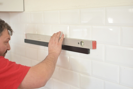 man works from spirit level
