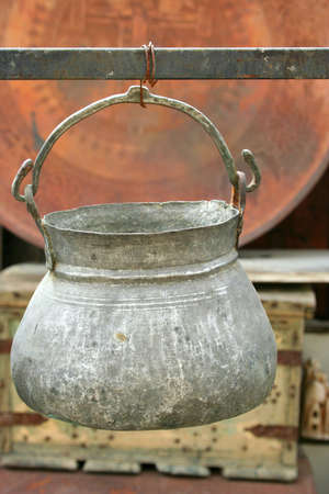 An antique pot hanging on display at a souvenir shopの写真素材