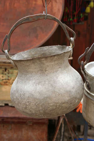 An antique pot hanging on display at a souvenir shop