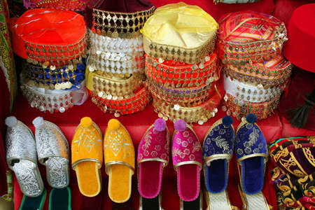 Traditional slippers and hats on display at a touristic street market in Istanbulの写真素材