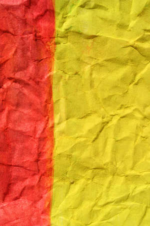 Red and yellow colors painted paper as background. Art is painted by photographer.の写真素材
