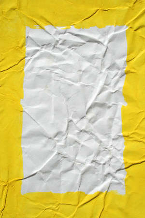 Yellow painted frame on wrinkled paper as backgroundの写真素材