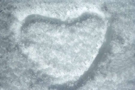 heart shape on icy snowの写真素材