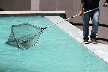 Man cleaning swimming-poolの写真素材